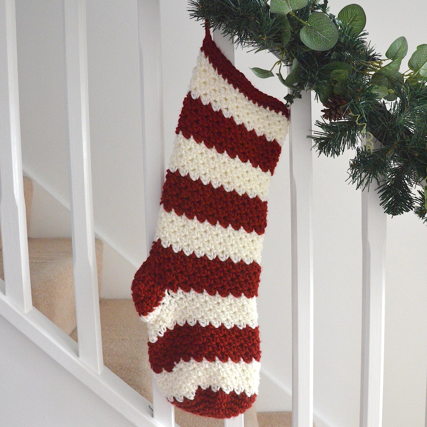Red Christmas stocking hanging on the stairs