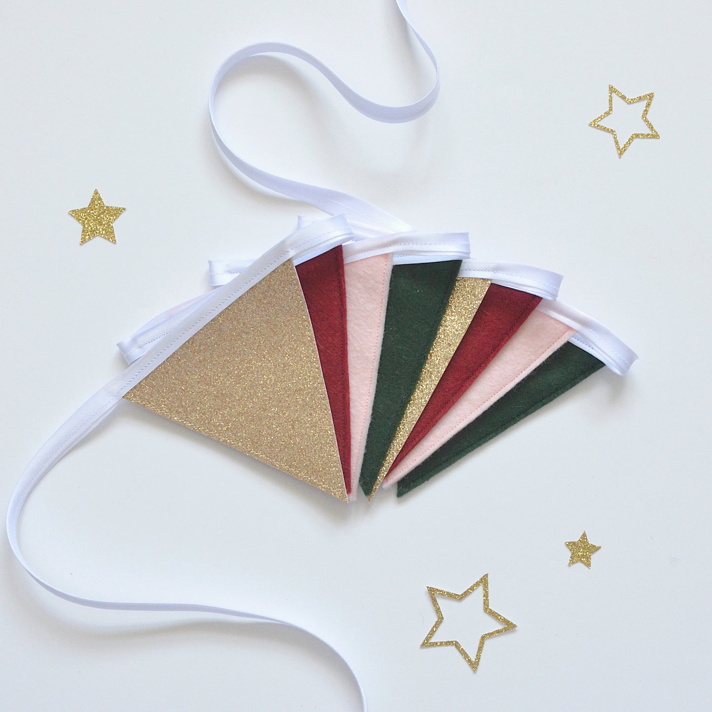 Decorative festive bunting with gold, red, pink and green flags