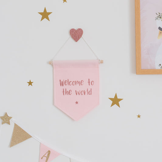 welcome to the world. Pink nursery banner
