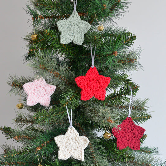 Star decorations hanging on a Christmas tree