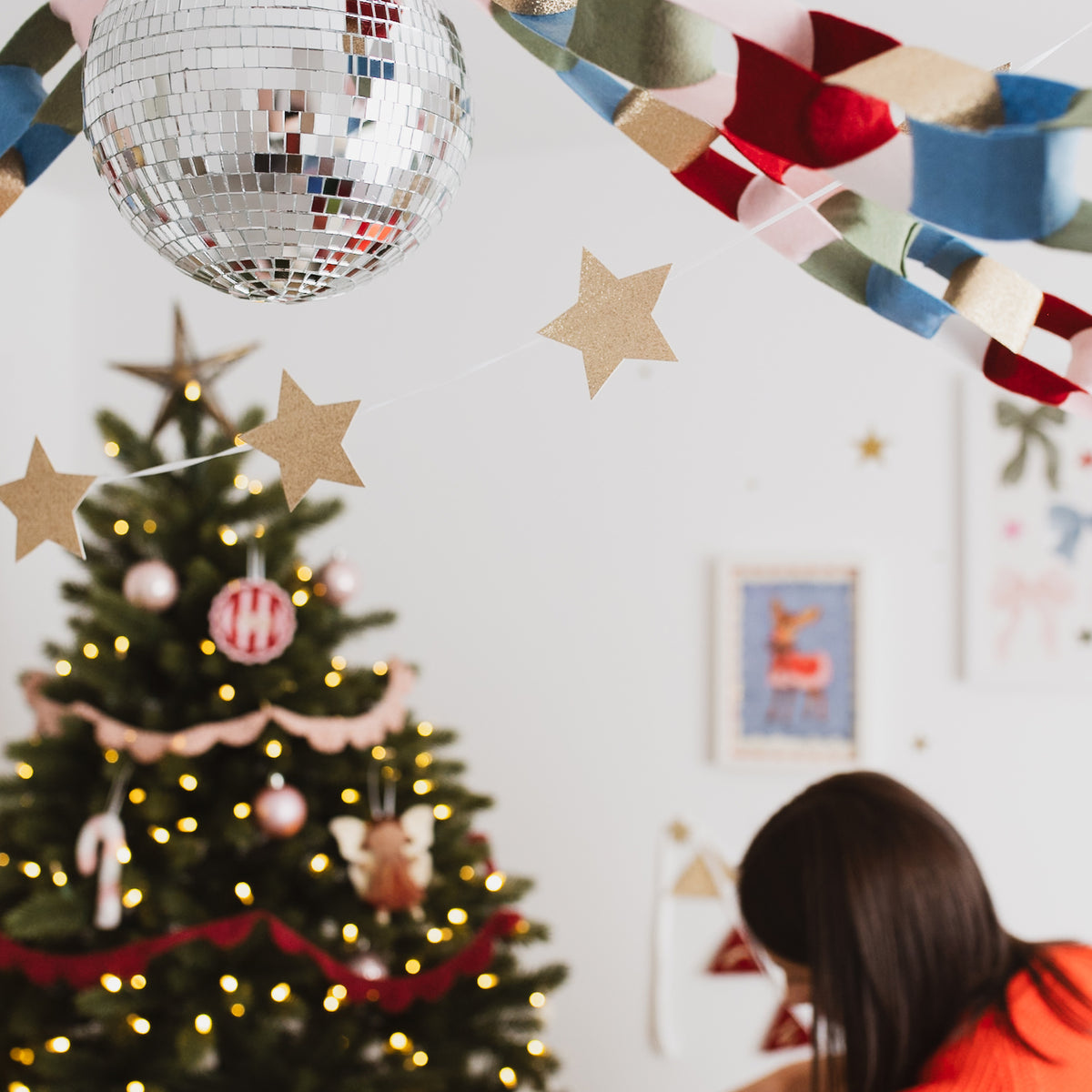 Gold star Christmas garland hanging across a ceiling