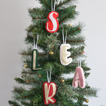 Handmade letter decorations on a Christmas Tree in various colours.
