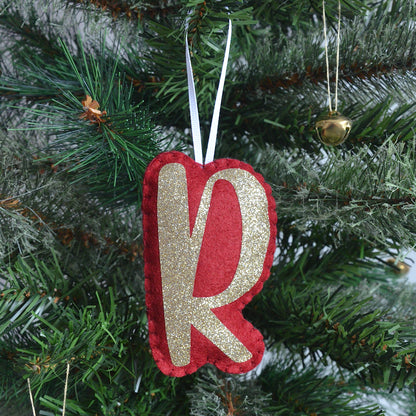 Personalised red and gold letter decoration on a Christmas tree