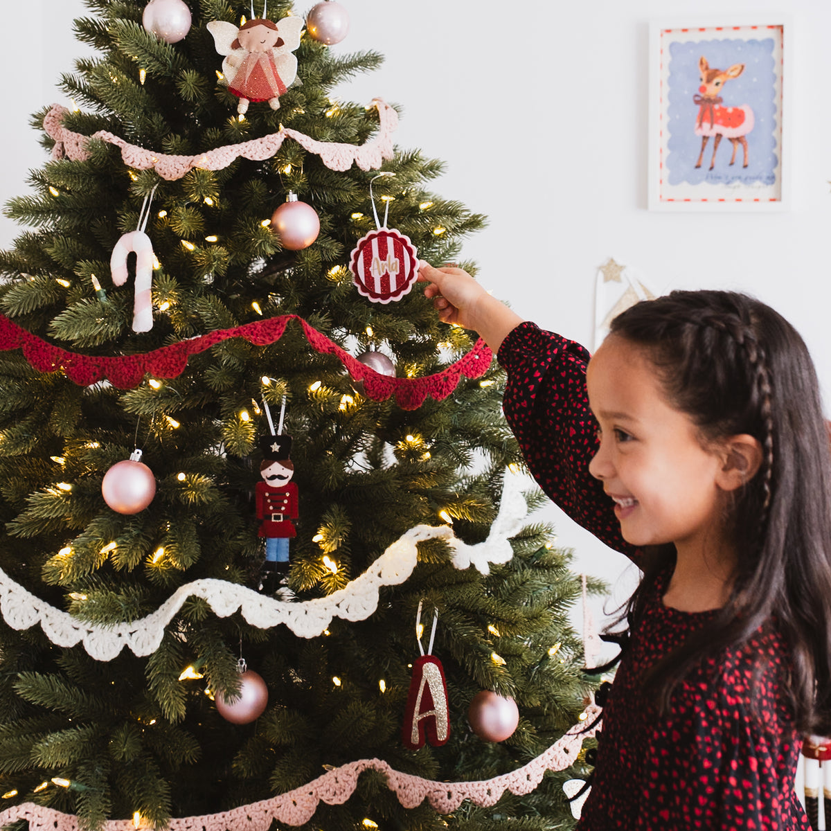 Personalised felt Christmas tree decoration hanging on a Christmas tree