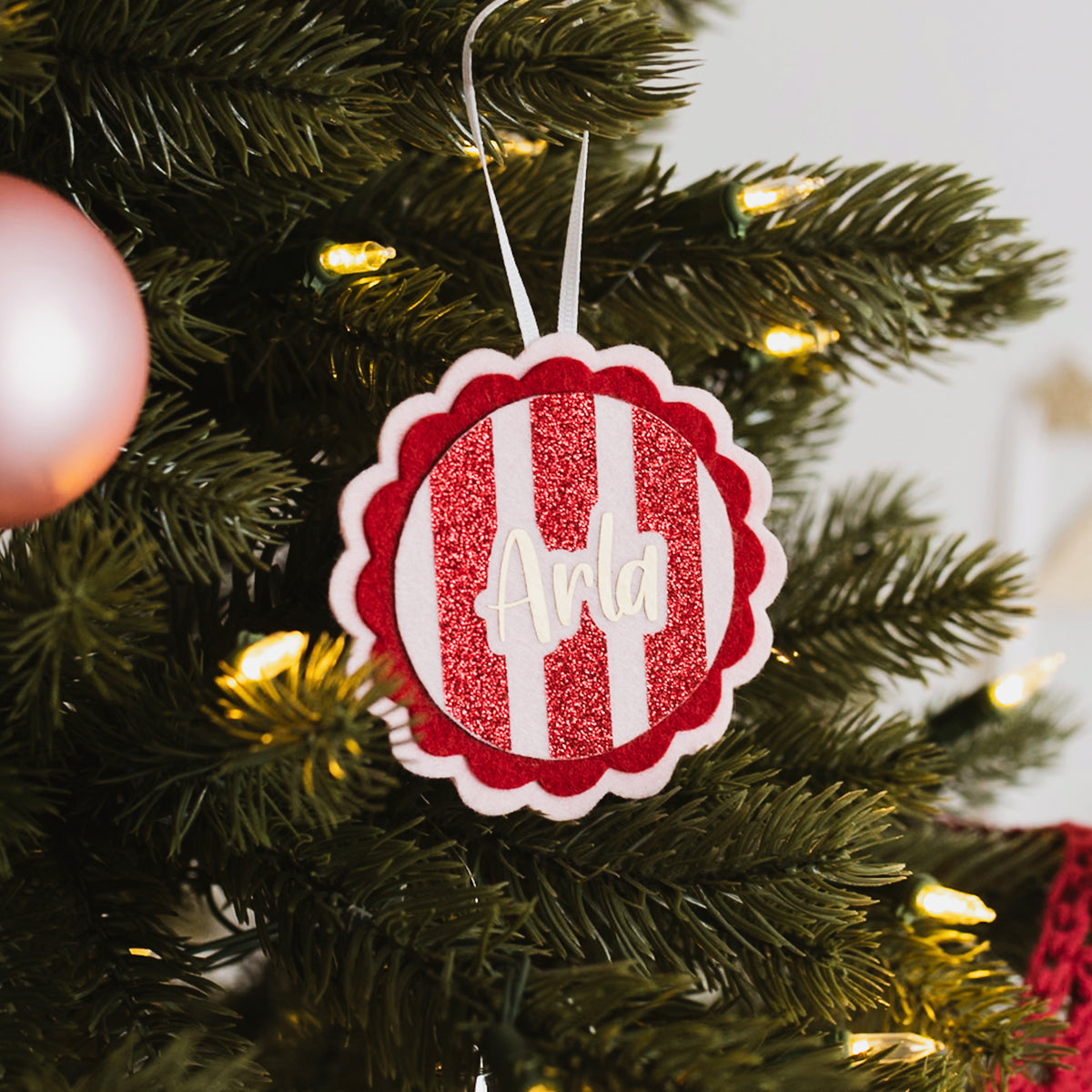 Personalised Christmas ornament decorating a festive Christmas tree