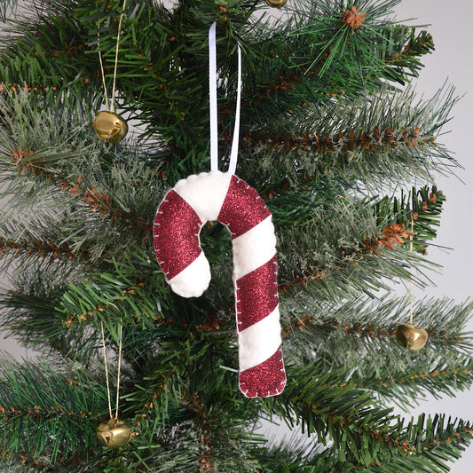 Red candy cane decoration hanging on a Christmas tree