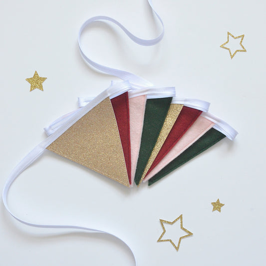 Decorative festive bunting with gold, red, pink and green flags