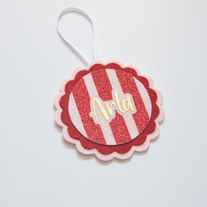 Close-up of handmade personalised felt Christmas decoration with glitter detail