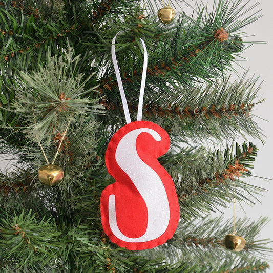Red and white letter decoration on a Christmas tree
