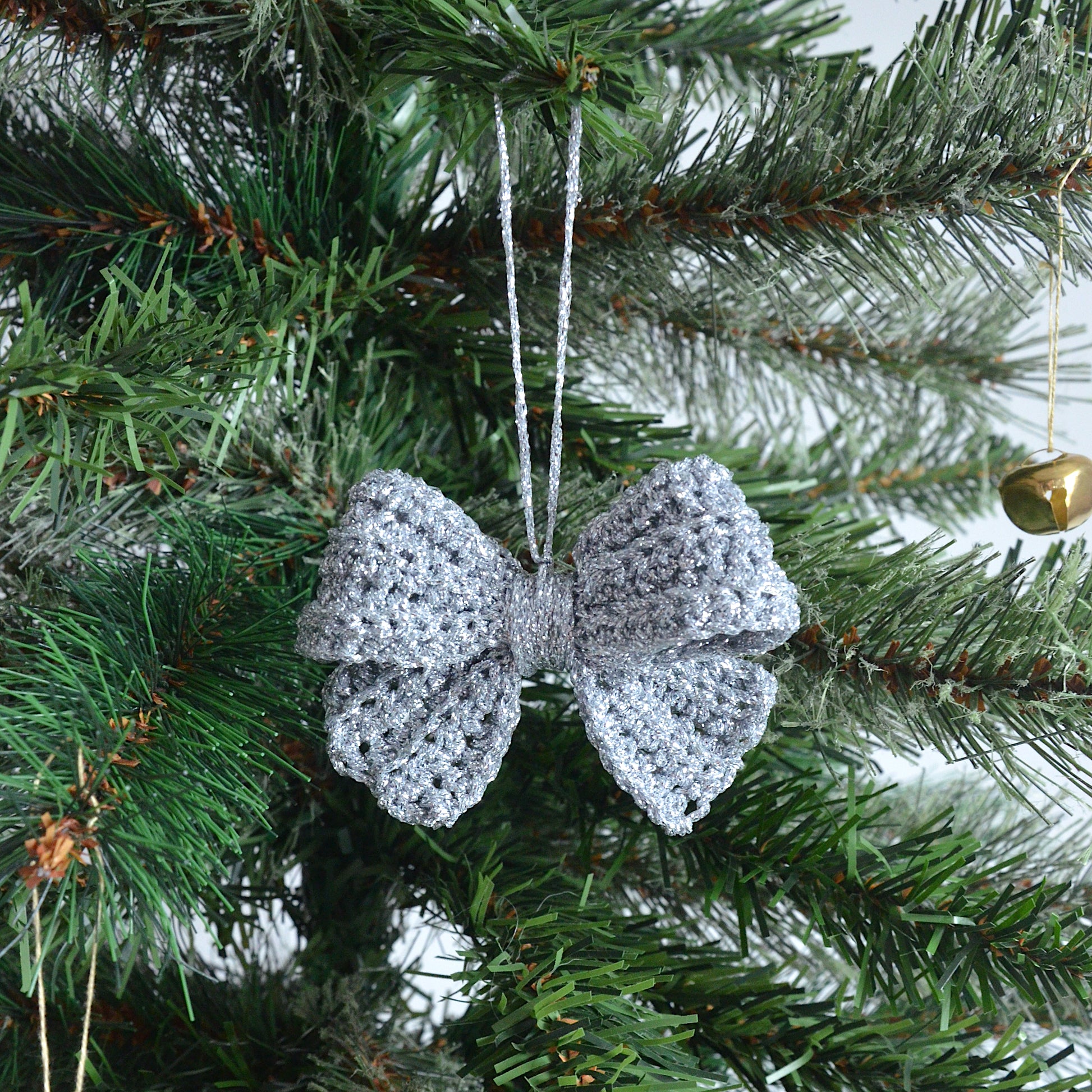 Silver crocheted bow decoration on a Christmas tree