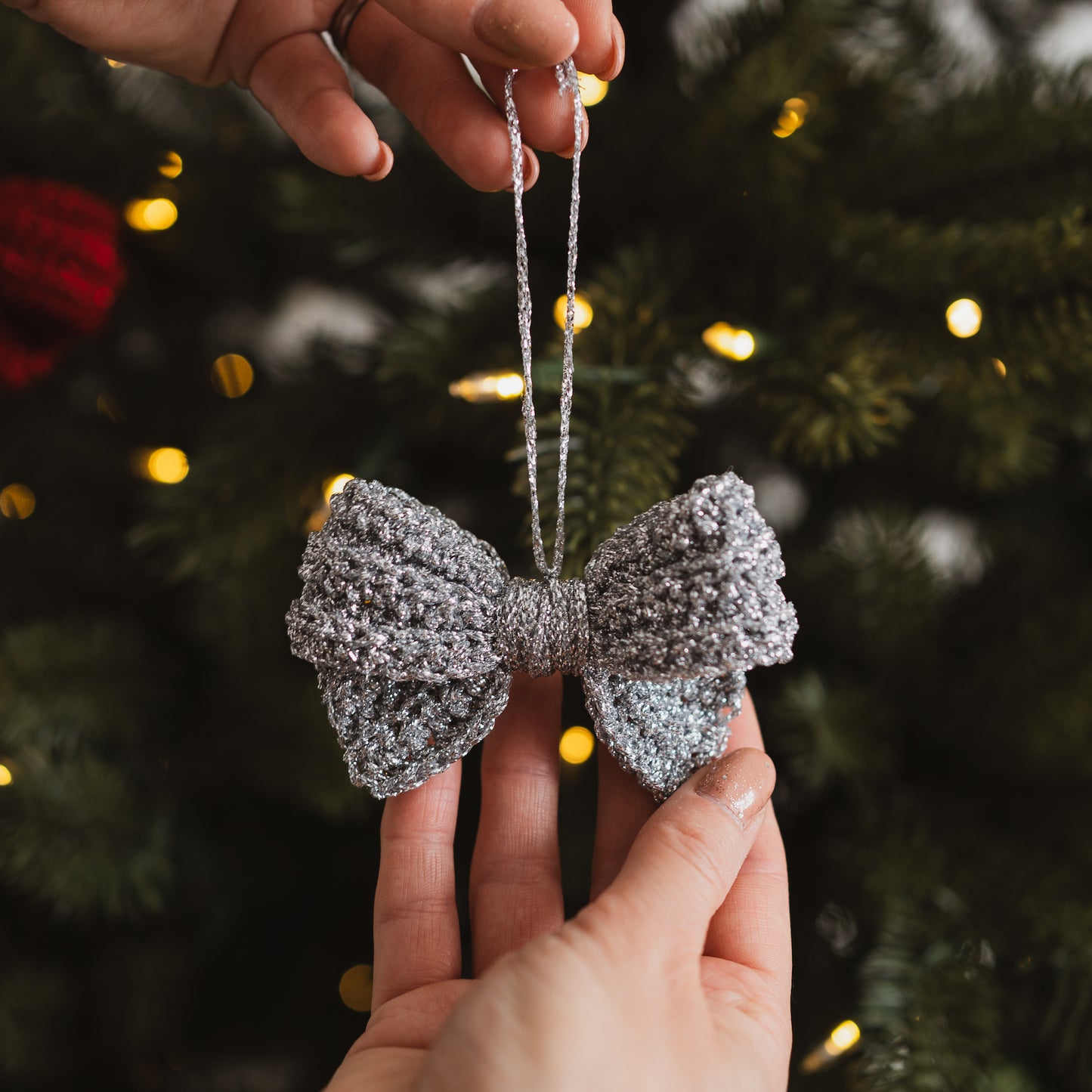 Silver crocheted bow decoration on a Christmas tree
