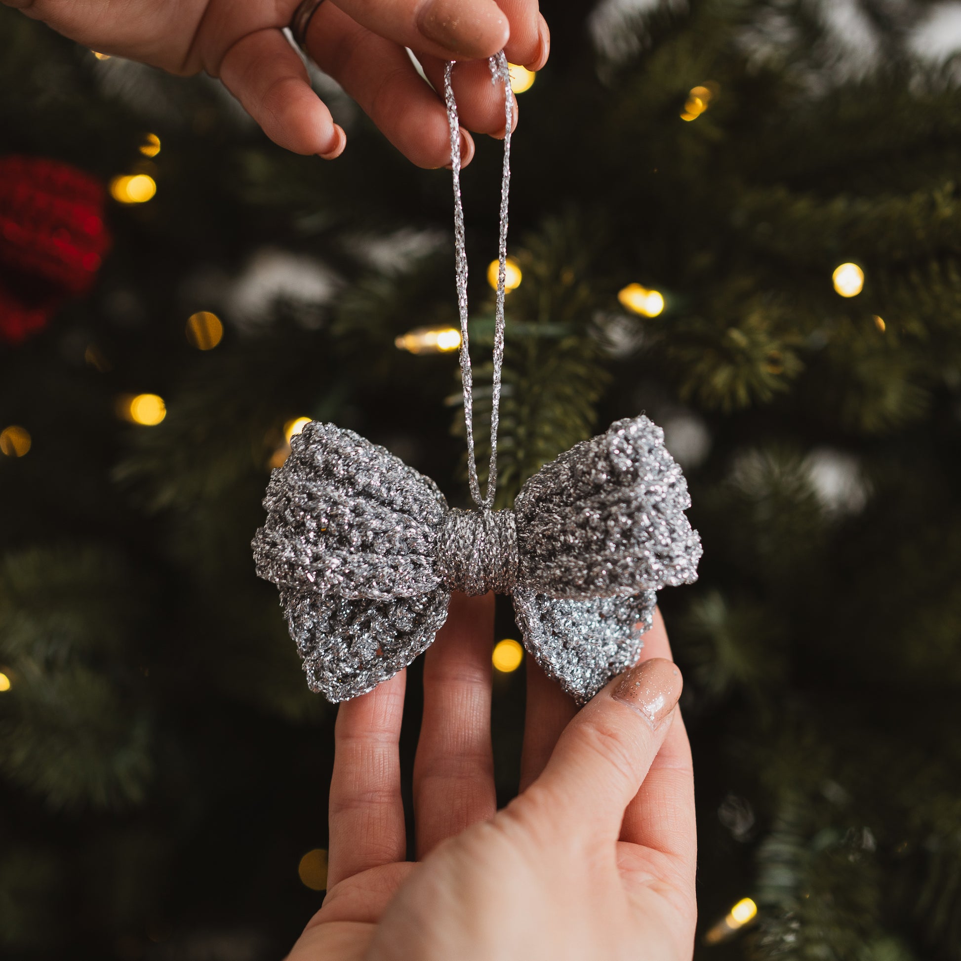 Silver crocheted bow decoration on a Christmas tree