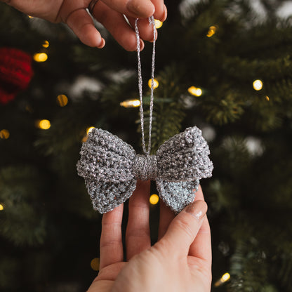 Silver crocheted bow decoration on a Christmas tree