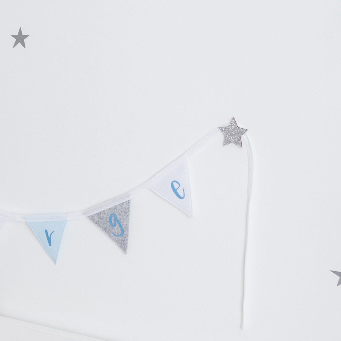 adhesive hooks to hang bunting in a child's room